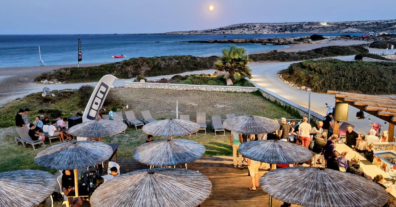 Sundown at the bar — Moonrise over the bay, thatched umbrellas, the day's wipeouts on repeat.